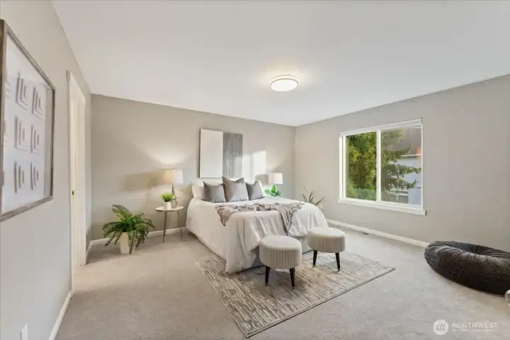 The primary bedroom is spacious and serene, offering a comfortable retreat at the end of the day.