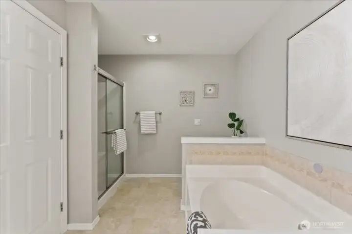 A separate shower and deep soaking tub create a relaxing retreat.