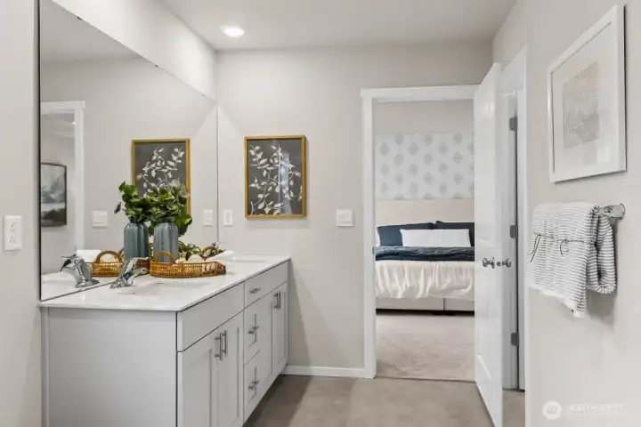 Primary bedroom offers connected bathroom with double vanity and separate door to toilet for privacy. Actual home is under construction. Colors, materials, and features may vary. See site agent for details.