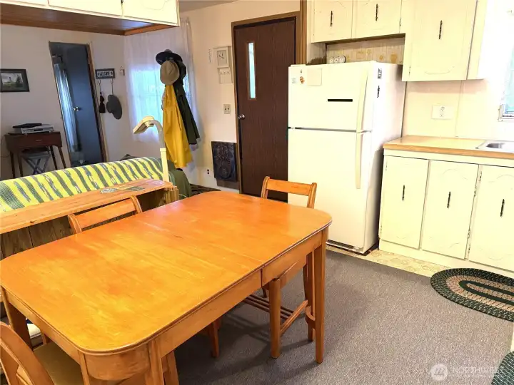 Kitchen centrally located, Table and appliances come with this home.