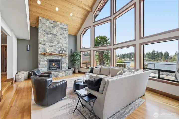 Enjoy the gas fireplace while looking out this wall of windows under beautiful vaulted ceilings.
