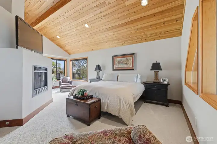 Top-floor primary suite has vaulted ceilings and a gas fireplace.