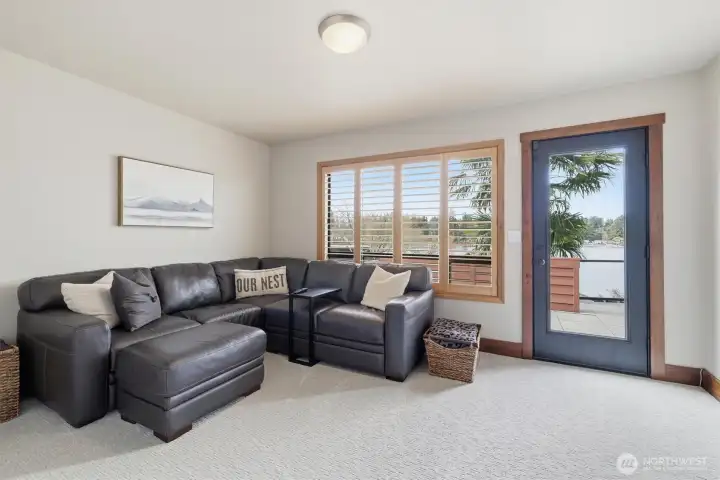 This main-floor office (or second bonus room) has access to the other side of the deck where there is an extra BBQ area.