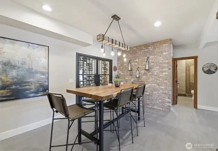 Downstairs dining room with real brick accent wall and wine cellar.