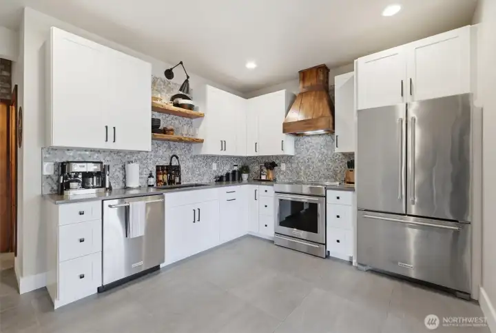 Second kitchen has high-end appliances and beautiful wood finishes.
