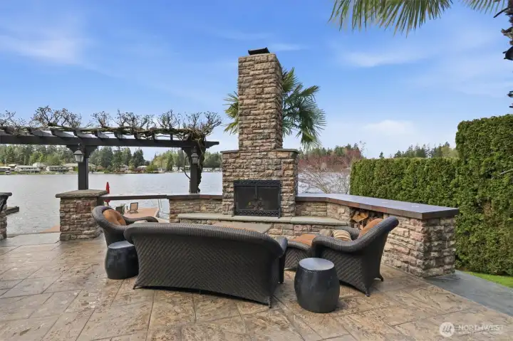 This outdoor seating area has a wood fireplace with gas starter.