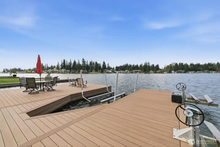 Amazing large dock with sitting area, boat slip with lift, and two jet ski lifts.  Dock surface was refinished in recent years.