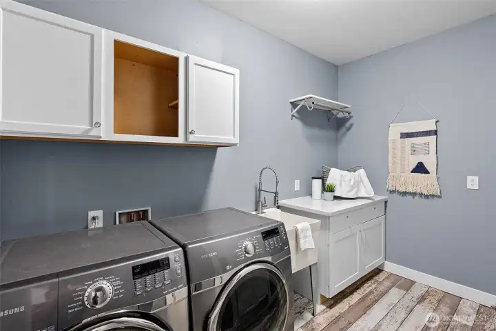 Main level utility room with access to garage