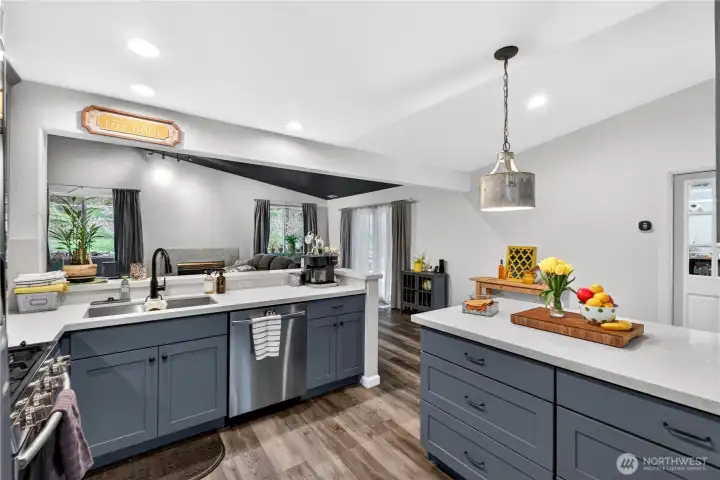 Designer kitchen featuring quartz countertops, a spacious island, and stylish cabinetry—perfectly positioned for seamless connection to the living area.