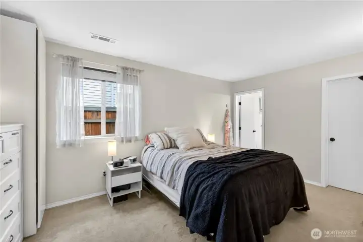 Bright and comfortable bedroom retreat with soft natural light and a peaceful, relaxing atmosphere.