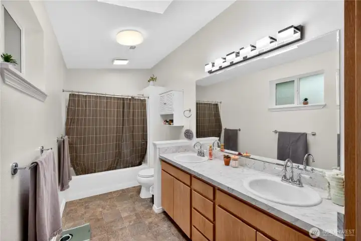 Spacious full bath with dual vanity, ample counter space, and a functional layout designed for everyday ease.