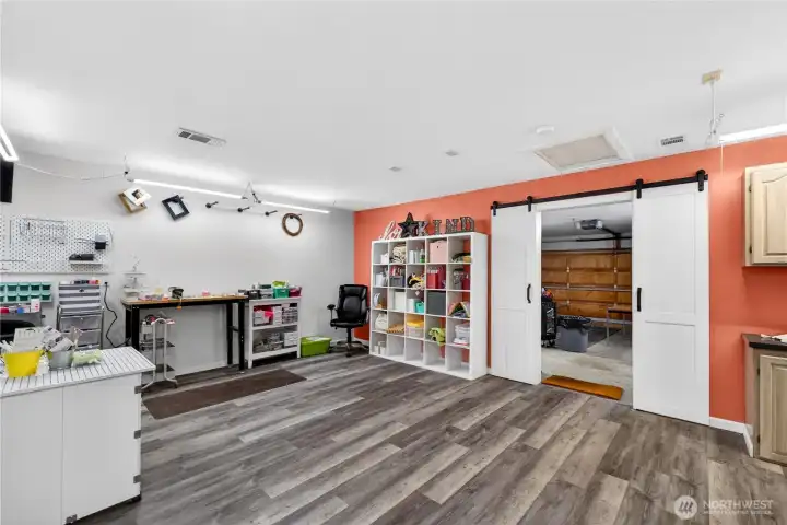 Spacious bonus area with sliding barn doors—ideal for hobbies, a studio, or extended workspace.