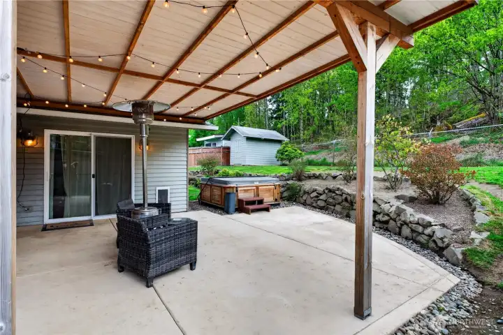 Relax and unwind in your private outdoor retreat featuring a covered patio and hot tub.