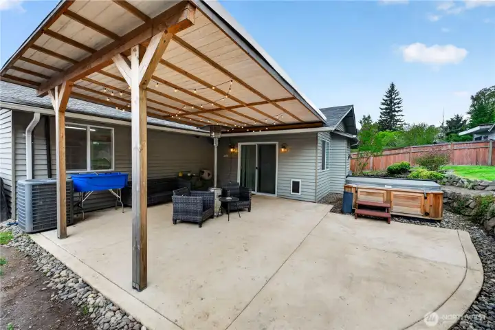 Expansive covered patio offers ample space for lounging, dining, and gathering.