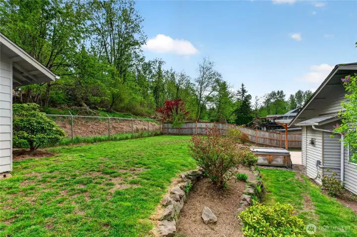 Private backyard with beautifully tiered landscaping, offering dimension, charm, and space to relax, garden, or entertain.
