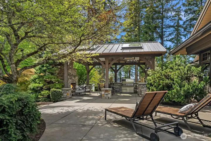 True indoor-outdoor living in the exquisite zen-like gardens with lounge, kitchen, and grand fireplace.
