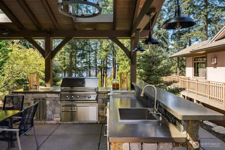 True indoor-outdoor living in the exquisite zen-like gardens with lounge, kitchen, and grand fireplace.