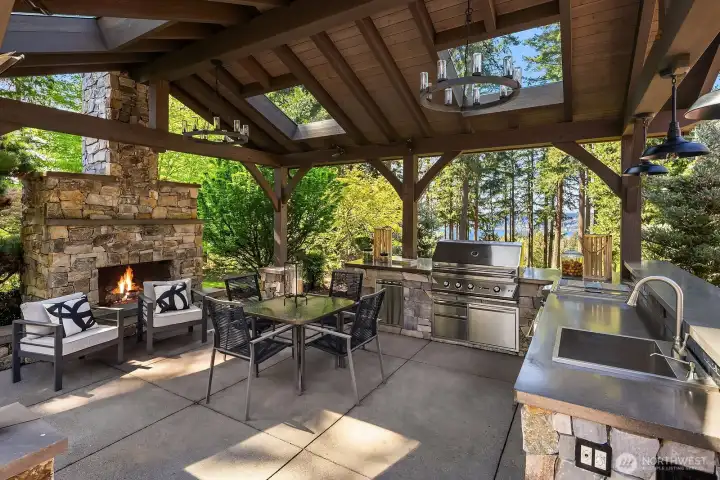 True indoor-outdoor living in the exquisite zen-like gardens with lounge, kitchen, and grand fireplace.