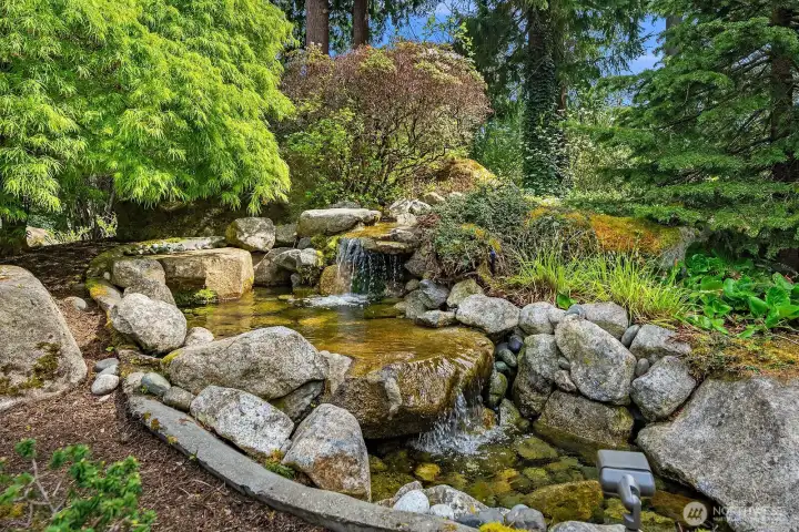Cascading water feature with multiple serene ponds.