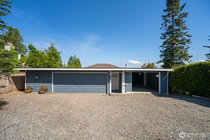 This lovely features garage to park 3 cars plus a separate workshop and bathroom room. There is also an attached carport.