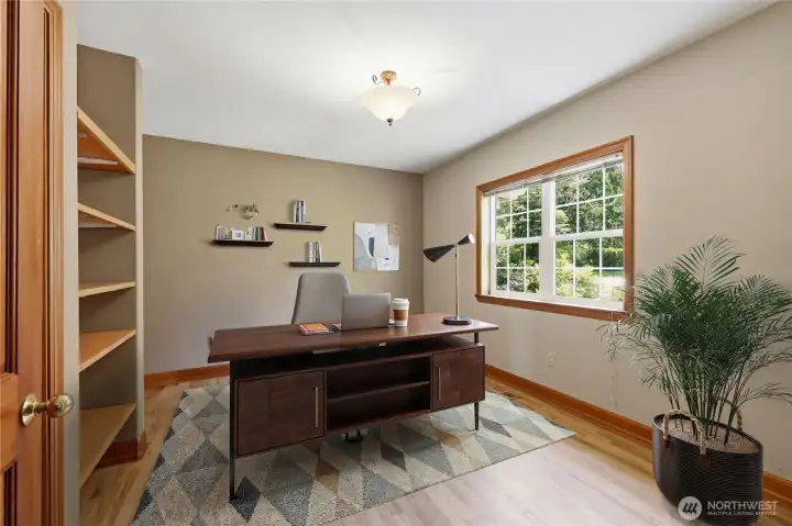 Office/Den is off the entry with a garden view, open shelving.