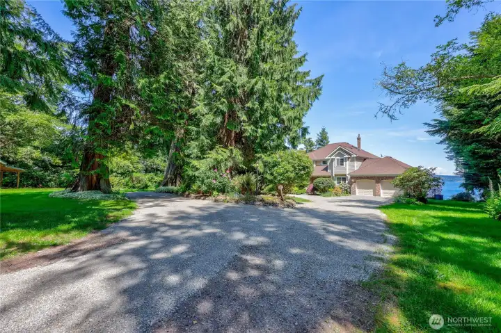 As you enter the property, you are greeted by beautiful mature landscaping.