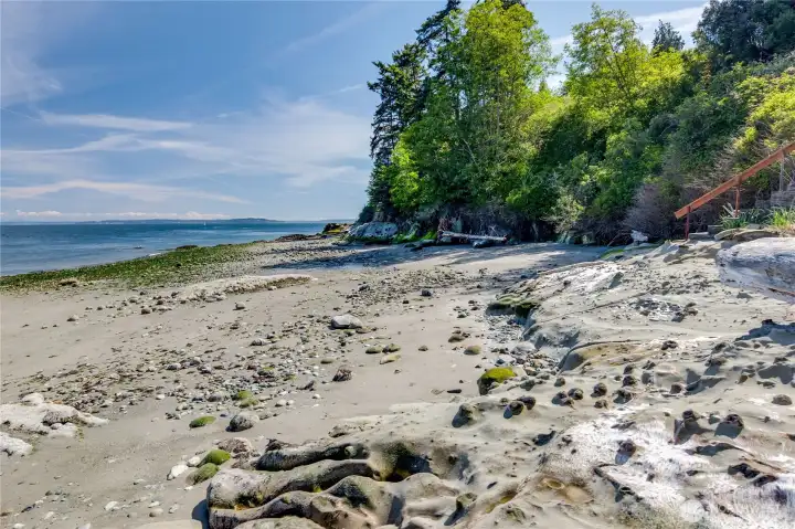 Lovely beach below your high bank estate.