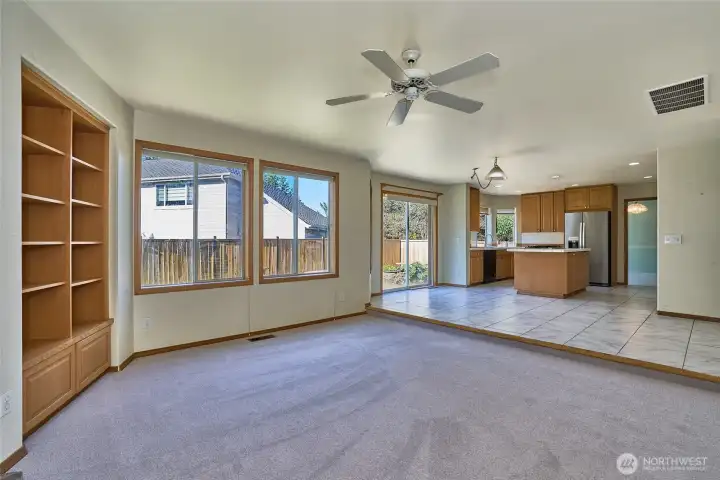 Family Room View with Built-In Shelves, Ceiling Fan. View looking into the Breakfast Nook and Kitchen. Family Room View with Built-In Shelves, Ceiling Fan. View looking into the Breakfast Nook and Kitchen.