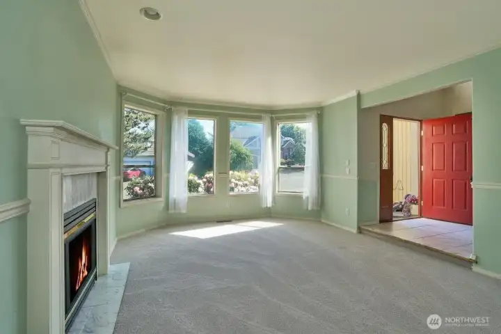 Large Formal Living Room with Tile Surround Gas Fireplace, Chair Rail and View of the Foyer. Large Formal Living Room with Tile Surround Gas Fireplace, Chair Rail and View of the Foyer.