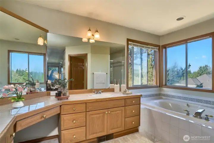 Immaculate 5 Piece Primary Bathroom with Dual Sinks, Soaking Tub, Tile Countertops and Tile Flooring. Immaculate 5 Piece Primary Bathroom with Dual Sinks, Soaking Tub, Tile Countertops and Tile Flooring.