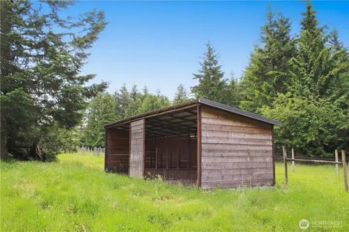 Loafing shed in fenced pasture