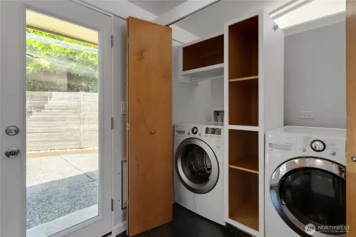 Utility space with washer & dryer that stays and complete with storage and hanging space.