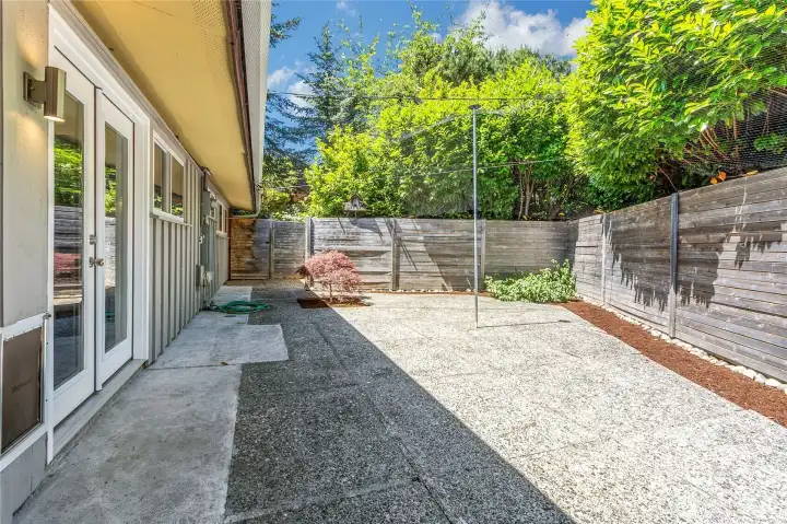 Back patio area is currently set up as a "catio" space (netting to keep your feline securely inside your yard area). Perfect area for grilling, or lounging with your favorite morning and evening beverage.
