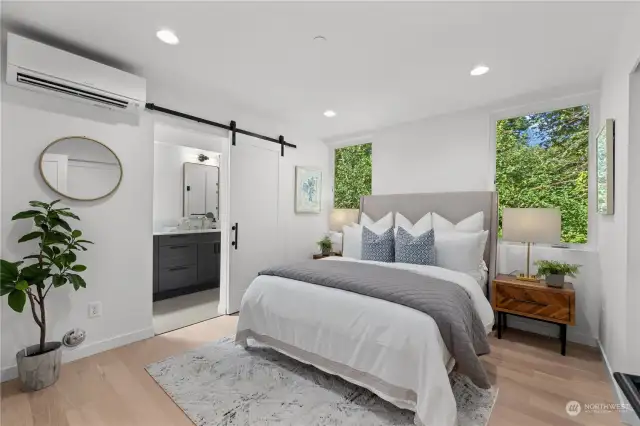 Peaceful master bedroom with a private en-suite and calming forest views.