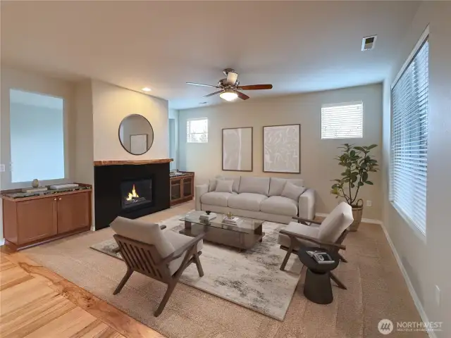 Living Room features gas fireplace, natural light, and a window that looks out to the covered patio with outdoor fireplace.
