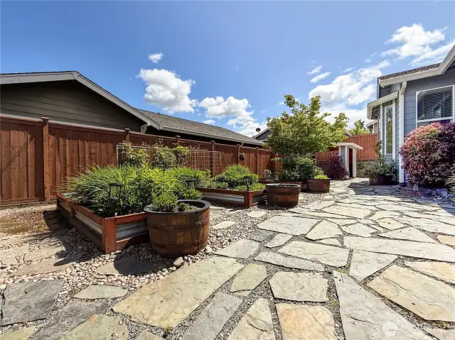 Expansive low maintenance yard with a stunning garden space. Backyard has a custom sprinkler and drip system to water large raised garden beds, 6 blueberry bushes and 6 raspberry.