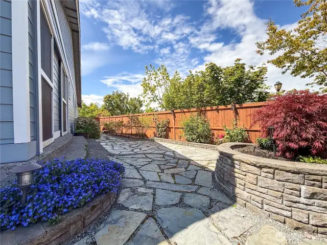 Expansive low maintenance yard with a stunning garden space. Backyard has a custom sprinkler and drip system to water large raised garden beds, 6 blueberry bushes and 6 raspberry.