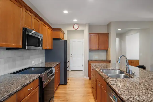 Kitchen features maple cabinetry, solar tube for stunning light, granite counter tops, Bosch dishwasher, Bespoke Refrigerator, new induction range, touch faucet and pull out drawers.
