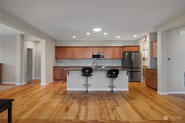 Kitchen features maple cabinetry, solar tube for stunning light, granite counter tops, Bosch dishwasher, Bespoke Refrigerator, new induction range, touch faucet and pull out drawers.
