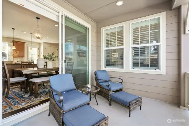 Oversized glass sliding doors to the covered front balcony