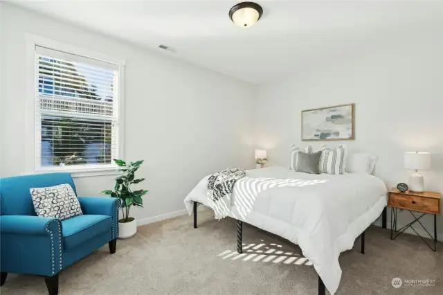 Main floor bedroom down the hallway is perfect for guests