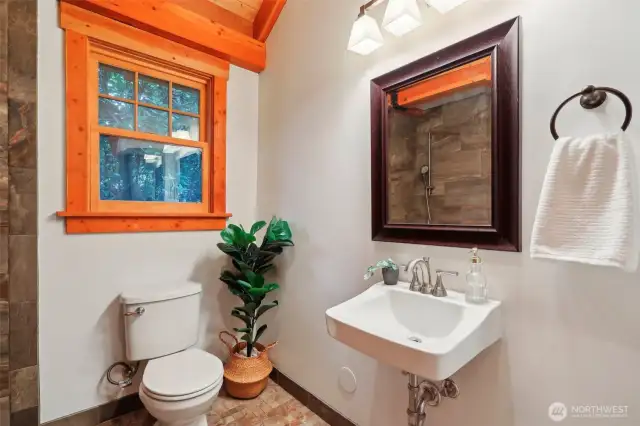 Three quarter bathroom with custom tiling.