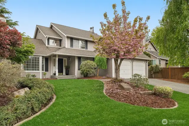 Front of home with mature landscape