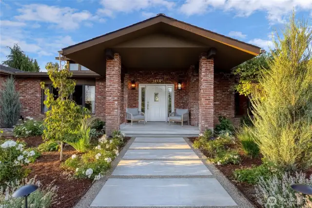 The thoughtfully redesigned concrete walkway & front entry patio is beautifully highlighted with professionally installed and curated front yard landscaping, by Lonna Lopez of Halo Garden Design