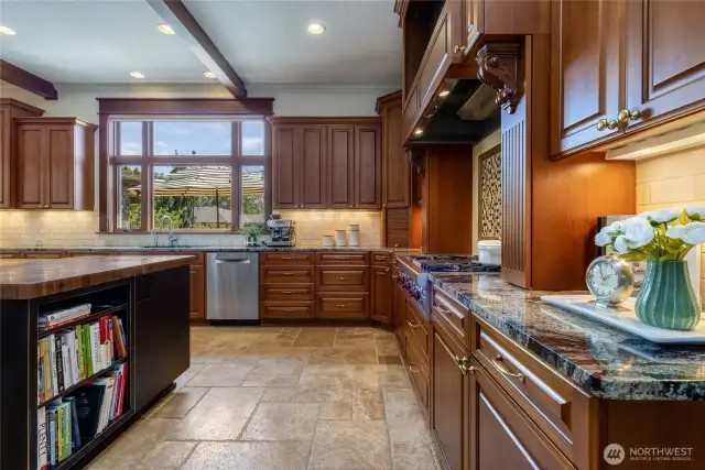 Butcher block top at the end of the island across from the Wolf range makes for a convenient and efficient prep area.