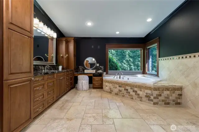 Jetted soaking tub with picture windows out to the private back yard.