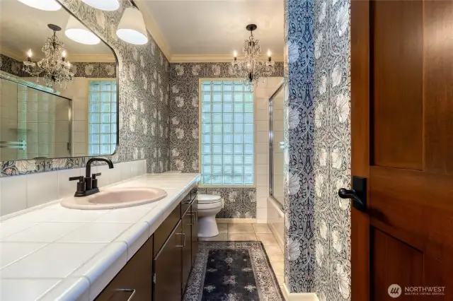 Guest bath on main level with professionally installed designer wallpaper.