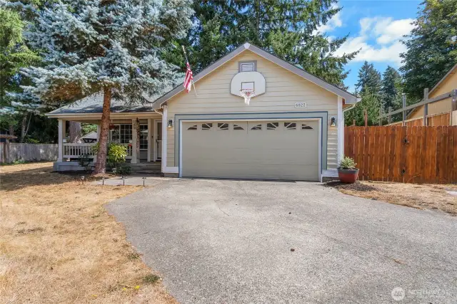 Charming two story home with covered front porch, full fenced yard and a looooong driveway!