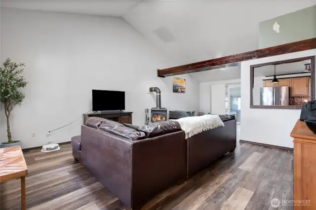 This great room concept offers vaulted ceiling, exposed beams, lovely dining room area and a large living/family room set up.