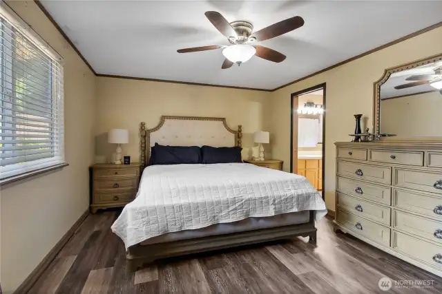 Another view of primary bedroom with full bath to the right
